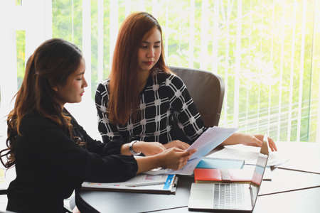 Business People Meeting to analyse and discuss and brainstorming the financial report chart data in office Financial advisor teamwork and accounting concept.の写真素材