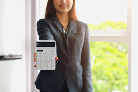 Business woman using office annual balance display calculator.accounting concept.の写真素材