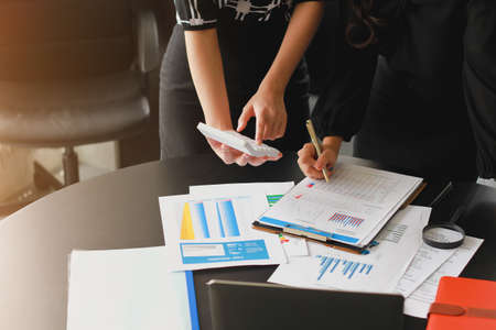 Business People Meeting to analyse and discuss and brainstorming the financial report chart data in office Financial advisor teamwork and accounting concept.の写真素材