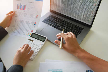 Business women who are using their fingers to press the calculator. Financial, accountant.