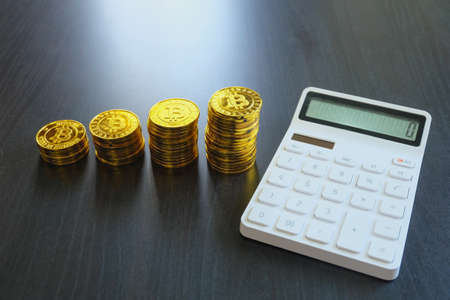 Concept save money, Stack gold coins on black the wooden table.の写真素材