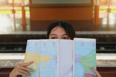 Summer, Travel, Vacation, Relax, A woman with a fresh smile and cute looks at a summer travel map at...