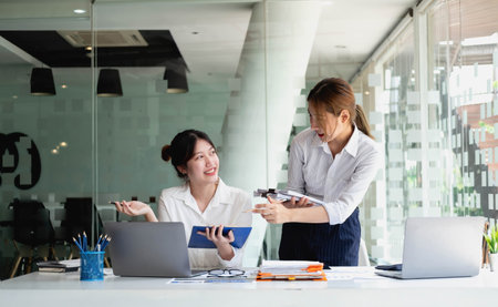 Marketing, Financial, Accounting, Planning, Team of female businessmen and economists use calculators and computers and graph documents to profit the company.の写真素材
