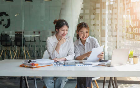 Marketing, Financial, Accounting, Planning, Team of female businessmen and economists use calculators and computers and graph documents to profit the company.の写真素材