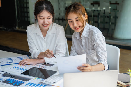 Marketing, Financial, Accounting, Planning, Team of female businessmen and economists use calculators and computers and graph documents to profit the company.の写真素材