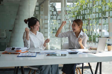 Marketing, Financial, Accounting, Planning, Businesswoman expressing joy that the company has profited from her team work.の写真素材