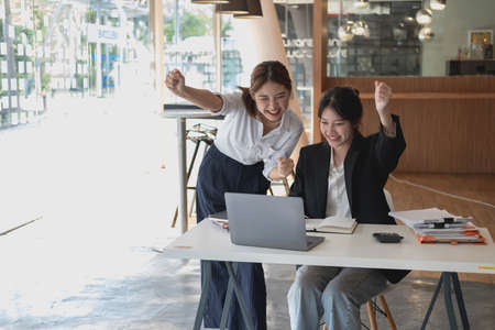 Marketing, Financial, Accounting, Planning, Businesswoman expressing joy that the company has profited from her team work.の写真素材