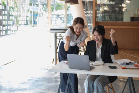 Marketing, Financial, Accounting, Planning, Businesswoman expressing joy that the company has profited from her team work.の写真素材