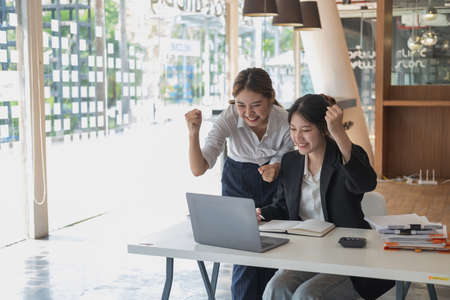 Marketing, Financial, Accounting, Planning, Businesswoman expressing joy that the company has profited from her team work.の写真素材