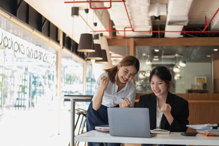 Marketing, Financial, Accounting, Planning, Businesswoman expressing joy that the company has profited from her team work.の写真素材
