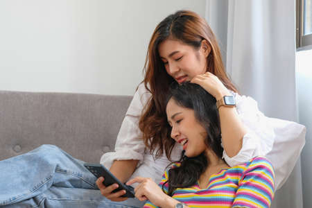 lgbtq, lgbt concept, homosexuality, two beautiful women showing their love to each other in a very warm home happilyの写真素材
