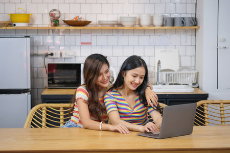 lgbtq, lgbt concept, homosexuality, two beautiful women showing their love to each other in a very warm home happilyの写真素材