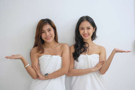 lgbtq, lgbt concept, homosexuality, two beautiful women in love happily playing tablet in a cozy homeの写真素材