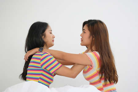 lgbtq, lgbt concept, homosexuality, two beautiful women showing their love to each other in a very warm home happilyの写真素材