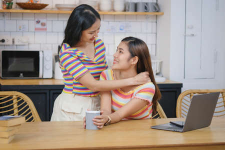 lgbtq, lgbt concept, homosexuality, two beautiful women showing their love to each other in a very warm home happilyの写真素材