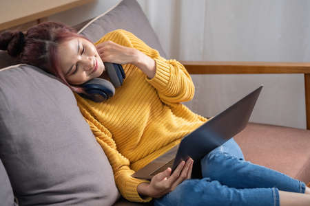 relax, de-stress, holiday, happy, Asian woman relaxing at home listening to music from smartphone...