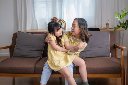 Portrait of an elderly woman and granddaughter hugging each other to show affection and family activities.の写真素材