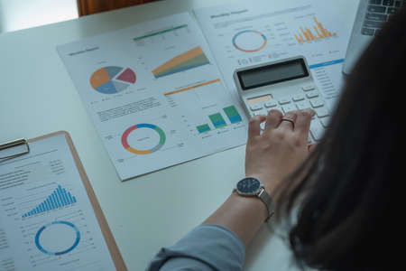 Marketing, Finance, Accounting, Planning, Businesswomen use calculators, computers, and graphs to...