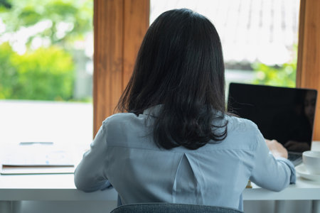 Marketing, Finance, Accounting, Planning, Businesswomen use calculators, computers, and graphs to analyze work to make the company profitable.の写真素材