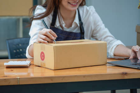 Online sales woman business owner Receive orders and deliver products with boxes to customers. Online SME business concept.の写真素材
