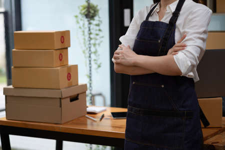 Online sales woman business owner Receive orders and deliver products with boxes to customers. Online SME business concept.の写真素材