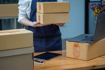 Online sales woman business owner Receive orders and deliver products with boxes to customers....
