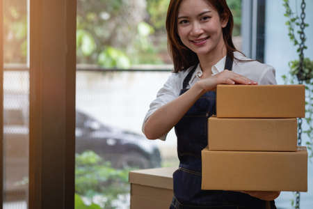 Online sales woman business owner Receive orders and deliver products with boxes to customers. Online SME business concept.の写真素材