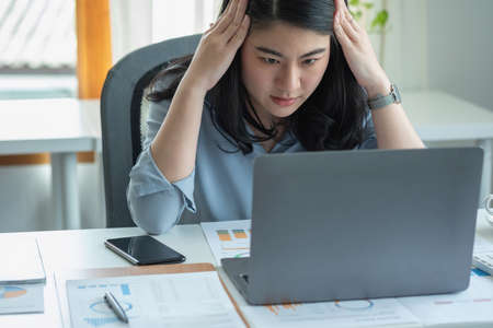 Concept Burnout Syndrome. Business Woman feels uncomfortable working. Which is caused by stress, accumulated from unsuccessful work And less resting body. Consult a specialist psychiatrist.の写真素材