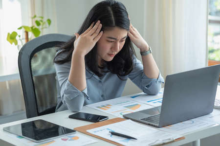 Concept Burnout Syndrome. Business Woman feels uncomfortable working. Which is caused by stress, accumulated from unsuccessful work And less resting body. Consult a specialist psychiatrist.の写真素材