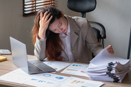 Businesswoman presenting profit data with graphs to her supervisor via laptop computer.