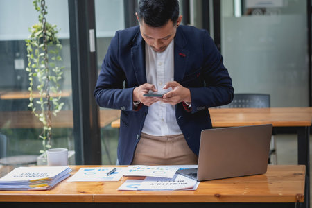 Marketing, Financial, Accounting, Planning, businessman uses a mobile phone to contact a customer to...