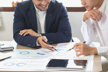 Marketing, Financial, Accounting, Planning, Team of business use calculators and graph analysis to plan marketing strategies and make profitable investments for the company.の写真素材