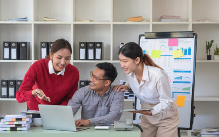 Accountant, businessman, The company is team of marketers analyzes the company is profits using laptop computer graphs and calculators.の写真素材