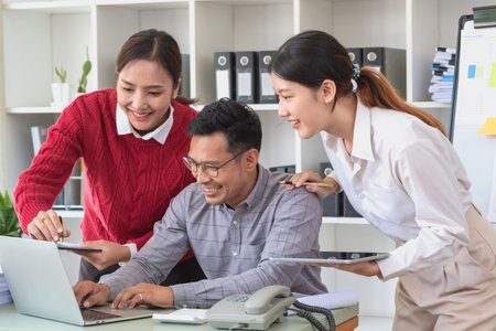 Marketing, Finance, Accounting, Planning, A team of businessmen plan with their laptops and graph charts for their profits and use a calculator to calculate their company is annual balance.の写真素材