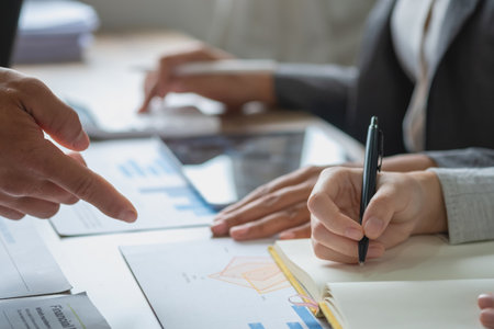 Marketing, Financial, Accounting, Planning, Team of business use calculators and graph analysis to plan marketing strategies and make profitable investments for the company.の写真素材