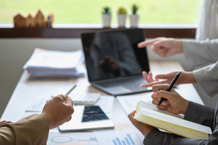 Marketing, Financial, Accounting, Planning, Team of business use calculators and graph analysis to plan marketing strategies and make profitable investments for the company.の写真素材