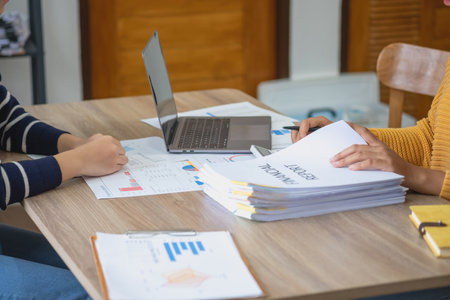 Marketing, Finance, Accounting, Planning, Team female accountant using laptop calculator and documents, charts, graphs in the analysis of the company is profit.の写真素材