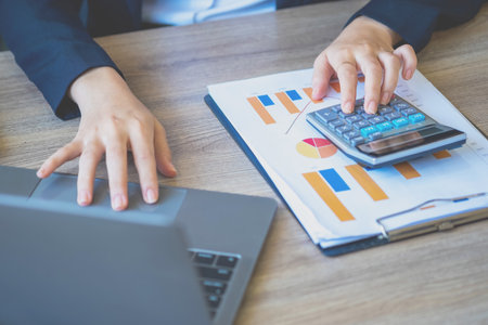 Marketing, Finance, Accounting, Planning, Team female accountant using laptop calculator and documents, charts, graphs in the analysis of the company is profit.の写真素材