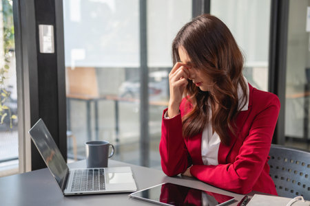 Concept Burnout Syndrome. Business Woman feels uncomfortable working. Which is caused by stress, accumulated from unsuccessful work And less resting body. Consult a specialist psychiatrist.の写真素材