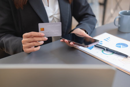 Young Asian woman shopping online using a credit card. for online payment within the house credit card payment conceptの写真素材