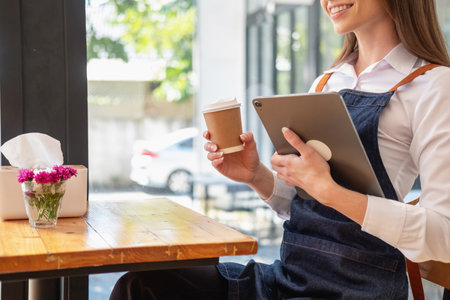 Portrait of a woman, a coffee shop business owner smiling beautifully and opening a coffee shop that is her own business, Small business concept.の写真素材