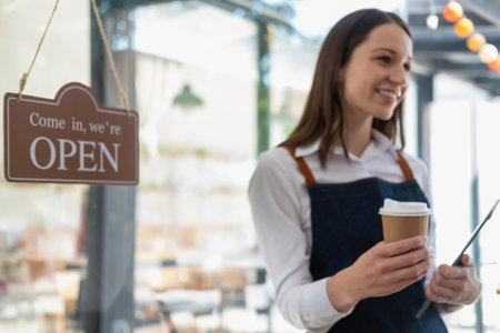 Portrait of a woman, a coffee shop business owner smiling beautifully and opening a coffee shop that is her own business, Small business concept.の写真素材
