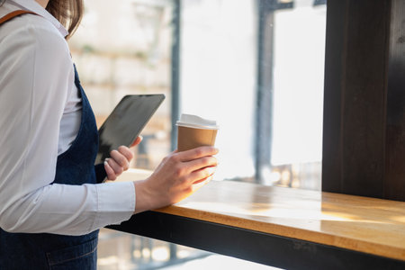Portrait of a woman, a coffee shop business owner smiling beautifully and opening a coffee shop that is her own business, Small business concept.の写真素材