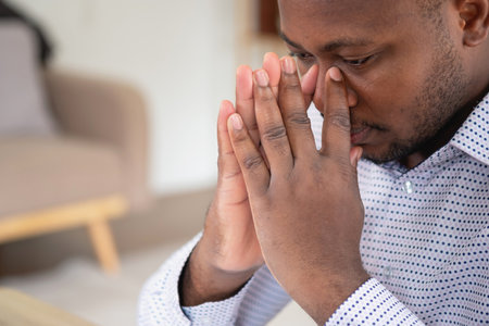 An American businessman with black skin in Africa feels uncomfortable at work and wrist pain is caused by the accumulated stress from failing to complete the job. and the body rests a little.の写真素材