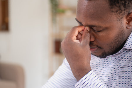 An American businessman with black skin in Africa feels uncomfortable at work and wrist pain is caused by the accumulated stress from failing to complete the job. and the body rests a little.の写真素材