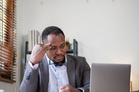 Concept Burnout Syndrome. African American businessman feels uncomfortable working, which is caused...