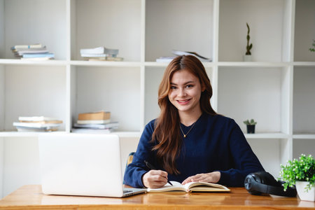 Happy young Latin female college student studying online remotely Distance university webinars Or...
