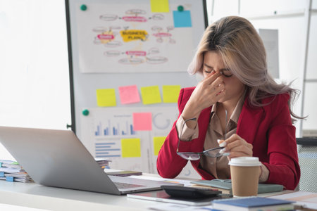 Concept Burnout Syndrome. Asian business Woman feels uncomfortable working. Which is caused by stress, accumulated from unsuccessful work And less resting body. Consult a specialist psychiatrist.の写真素材