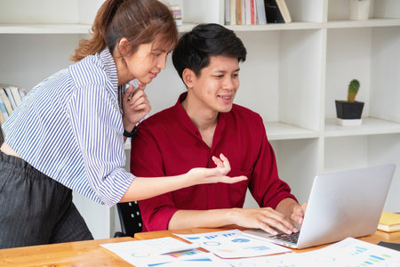 Marketing, Financial, Accounting, Planning, Team of business women analyze company results and profits with graph statistics. Use a laptop computer and a calculator to calculate the company balance.の写真素材