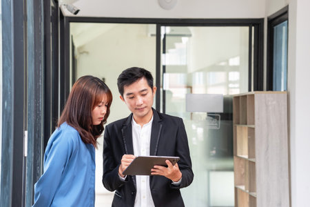 They are working, thinking, and planning on the tablet of a business team developing a project. The technology marketing group works with web research. Office workers are looking at tablets together.の写真素材